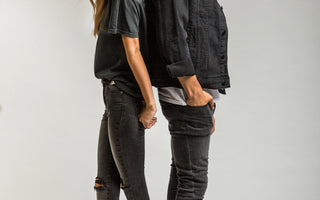 Man and woman in studio wearing denim standing back to back