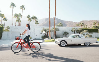 Woman riding red bike in down California street
