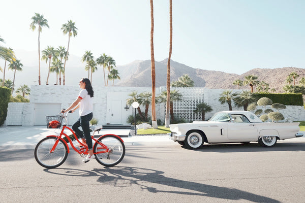 Woman riding red bike in down California street