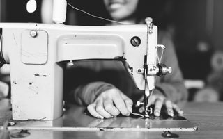 Outland denim seamstress at sewing machine