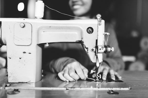 Outland denim seamstress at sewing machine