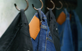 outland denim jeans hanging on hooks